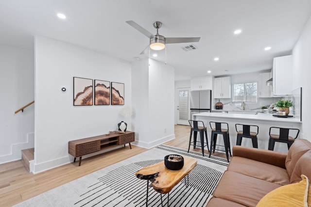 2706 Wheless Ln Unit 502, Austin, TX 78723 - living area with light wood finished floors, recessed lighting, a ceiling fan, and stairs