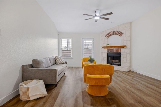 608 Timothy John Dr, Pflugerville, TX 78660 - living area with wood finished floors, ceiling fan, and a fireplace