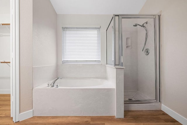 608 Timothy John Dr, Pflugerville, TX 78660 - full bath with a shower stall, a bath, wood finished floors, and a walk in closet