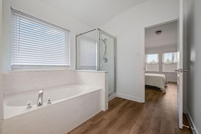 608 Timothy John Dr, Pflugerville, TX 78660 - bathroom featuring a shower stall, a bath, wood finished floors, and ensuite bath