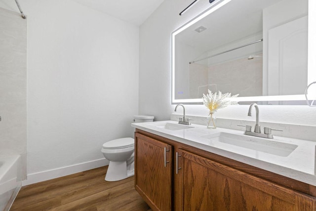 608 Timothy John Dr, Pflugerville, TX 78660 - bathroom featuring double vanity, wood finished floors, and shower / washtub combination