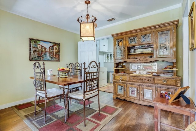 1506 Alguno Rd, Austin, TX 78757 - dining area with dark wood finished floors and crown molding