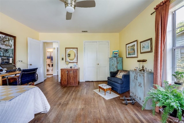1506 Alguno Rd, Austin, TX 78757 - bedroom featuring multiple windows, wood finished floors, and a ceiling fan