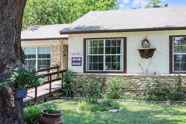 1506 Alguno Rd, Austin, TX 78757 - property entrance with stone siding, stucco siding, and a shingled roof
