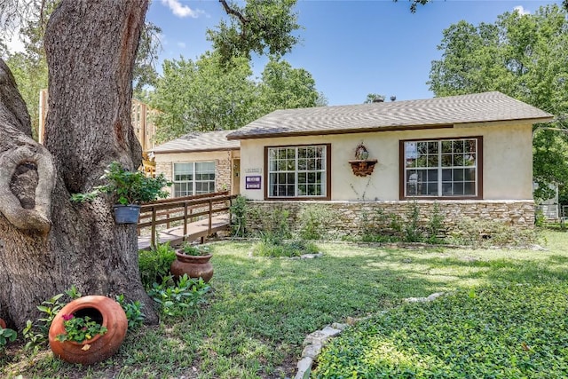 1506 Alguno Rd, Austin, TX 78757 - ranch-style house with stucco siding, stone siding, and a front yard