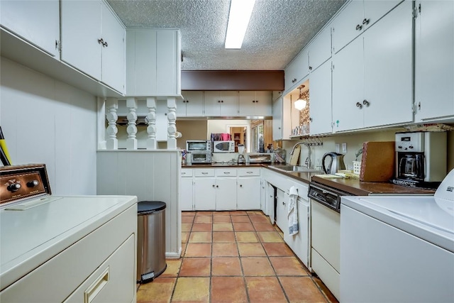 1506 Alguno Rd, Austin, TX 78757 - kitchen with a textured ceiling, white cabinetry, washer and clothes dryer, white microwave, and light tile patterned floors