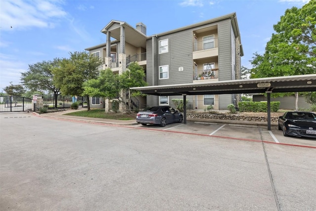 2320 Gracy Farms Ln Unit 323, Austin, TX 78758 - view of building exterior featuring covered parking