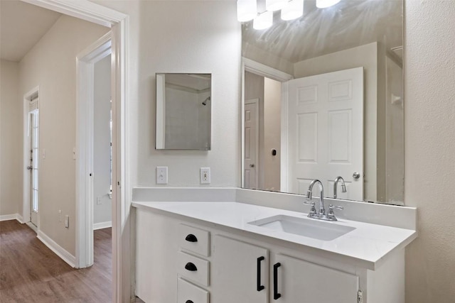 2320 Gracy Farms Ln Unit 323, Austin, TX 78758 - bathroom with wood finished floors and vanity