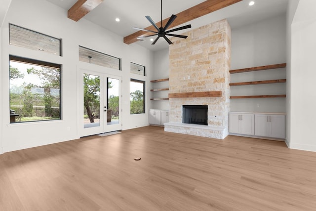 209 Burnet Oaks Dr, Burnet, TX 78611 - unfurnished living room with beamed ceiling, ceiling fan, light wood-style flooring, a high ceiling, and recessed lighting