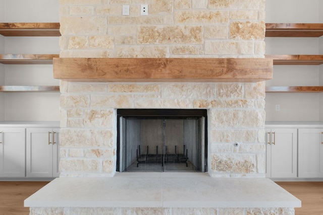 209 Burnet Oaks Dr, Burnet, TX 78611 - detailed view of wood finished floors and a fireplace with raised hearth