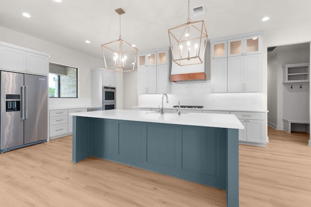 209 Burnet Oaks Dr, Burnet, TX 78611 - kitchen with appliances with stainless steel finishes, a chandelier, backsplash, light countertops, and recessed lighting