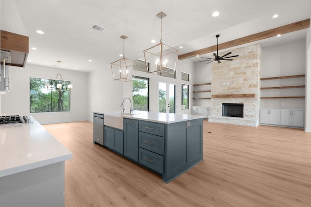 209 Burnet Oaks Dr, Burnet, TX 78611 - kitchen with light wood-style flooring, beam ceiling, recessed lighting, stainless steel appliances, and a chandelier