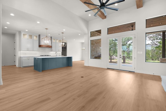 209 Burnet Oaks Dr, Burnet, TX 78611 - kitchen featuring white cabinetry, open floor plan, light wood-style flooring, decorative backsplash, and recessed lighting
