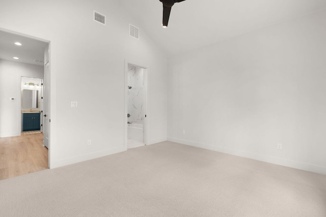 209 Burnet Oaks Dr, Burnet, TX 78611 - unfurnished bedroom featuring ensuite bath, light carpet, recessed lighting, and vaulted ceiling