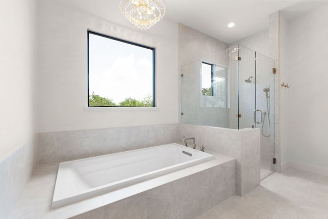 209 Burnet Oaks Dr, Burnet, TX 78611 - bathroom with a garden tub, a stall shower, a chandelier, and tile patterned flooring