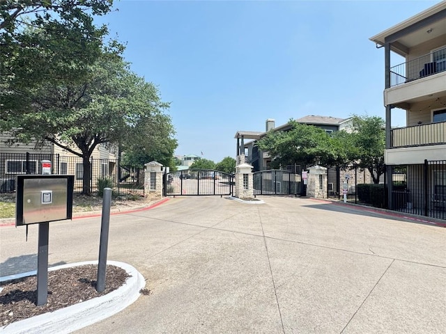2320 Gracy Farms Ln Unit 1432, Austin, TX 78758 - view of concrete road featuring a gate, a gated entry, and curbs