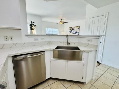 2320 Gracy Farms Ln Unit 1432, Austin, TX 78758 - kitchen featuring dishwasher, ceiling fan, light tile patterned flooring, white cabinetry, and light stone countertops