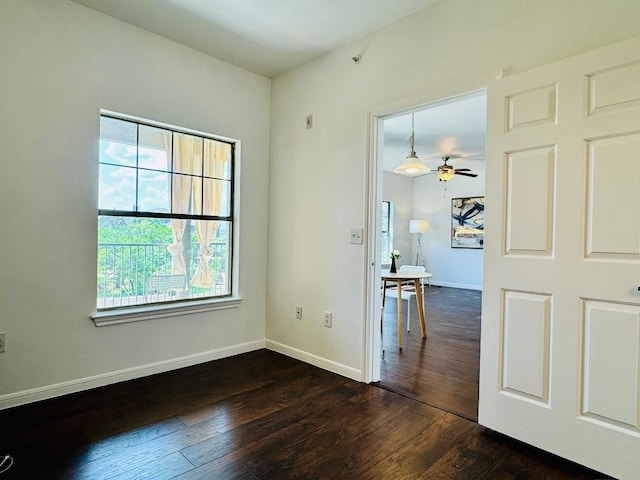 2320 Gracy Farms Ln Unit 1432, Austin, TX 78758 - empty room with dark wood finished floors and a ceiling fan