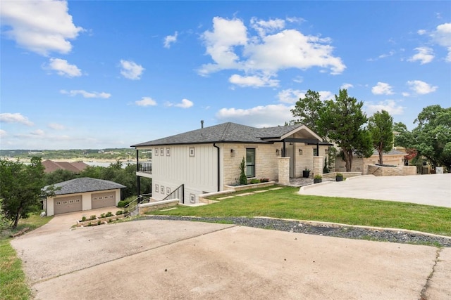 18924 Peckham Dr, Point Venture, TX 78645 - ranch-style house with stone siding, a detached garage, a front lawn, and an outbuilding