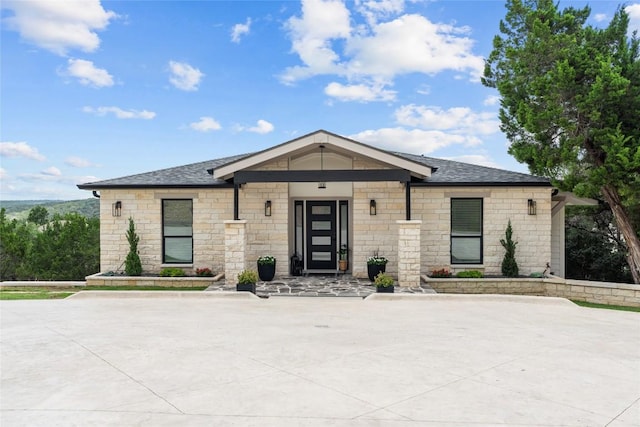 18924 Peckham Dr, Point Venture, TX 78645 - view of front facade with stone siding and a shingled roof