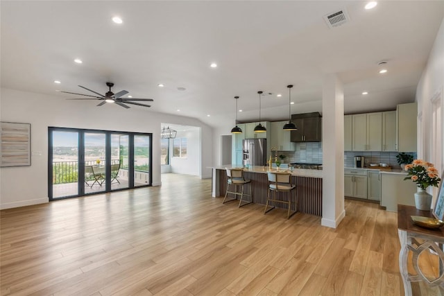 18924 Peckham Dr, Point Venture, TX 78645 - kitchen with high end fridge, recessed lighting, light countertops, tasteful backsplash, and open floor plan