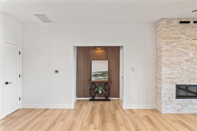 18924 Peckham Dr, Point Venture, TX 78645 - unfurnished living room featuring wood finished floors and a stone fireplace