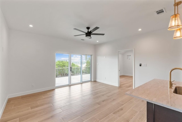 18924 Peckham Dr, Point Venture, TX 78645 - unfurnished living room with a ceiling fan, light wood finished floors, and recessed lighting