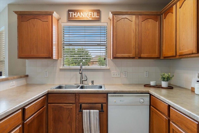 327 Lakemont Dr, Hutto, TX 78634 - kitchen featuring white dishwasher, tasteful backsplash, light countertops, and brown cabinets