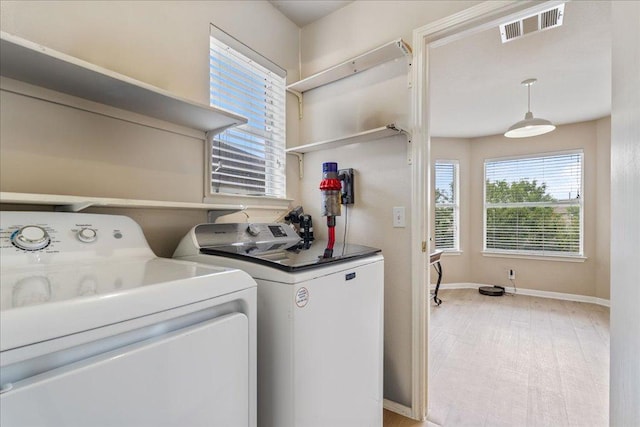 327 Lakemont Dr, Hutto, TX 78634 - laundry room featuring washer and dryer and baseboards