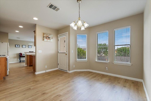 327 Lakemont Dr, Hutto, TX 78634 - unfurnished dining area featuring a chandelier, light wood-style flooring, and recessed lighting
