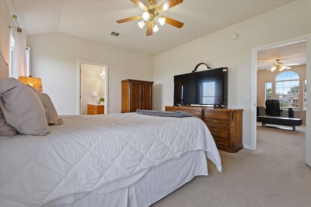 327 Lakemont Dr, Hutto, TX 78634 - bedroom with light colored carpet, vaulted ceiling, a ceiling fan, and ensuite bathroom