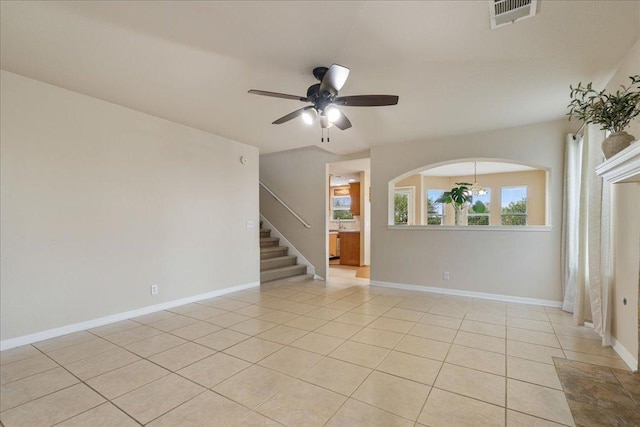 327 Lakemont Dr, Hutto, TX 78634 - empty room with ceiling fan, light tile patterned floors, and stairway