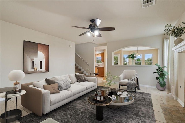 327 Lakemont Dr, Hutto, TX 78634 - living area with light tile patterned floors, a ceiling fan, and stairs