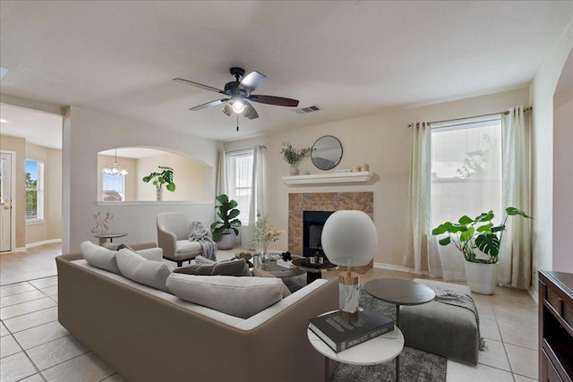 327 Lakemont Dr, Hutto, TX 78634 - living area with a tiled fireplace, light tile patterned floors, and ceiling fan