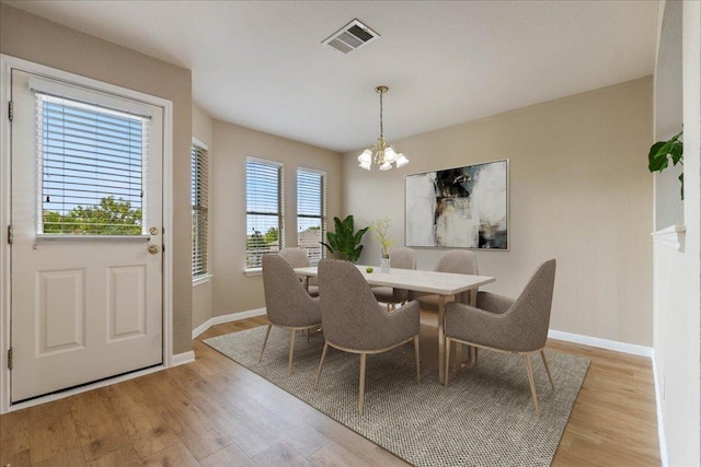327 Lakemont Dr, Hutto, TX 78634 - dining space with a chandelier and light wood-style floors
