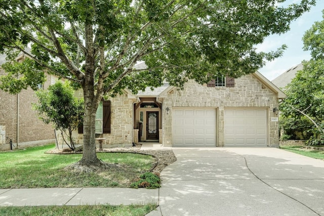 12421 Black Hills Dr, Austin, TX 78748 - view of front of home featuring stone siding, driveway, a garage, and a front yard