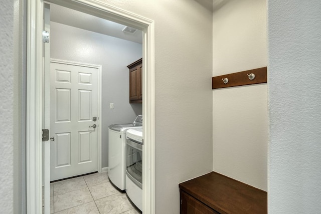 12421 Black Hills Dr, Austin, TX 78748 - washroom featuring cabinet space, separate washer and dryer, and light tile patterned floors