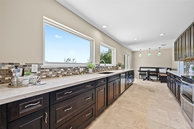 2512 Regal Park Ln, Austin, TX 78748 - kitchen with decorative backsplash, appliances with stainless steel finishes, light stone counters, recessed lighting, and decorative light fixtures