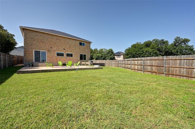2512 Regal Park Ln, Austin, TX 78748 - rear view of house with a fenced backyard, brick siding, and a patio