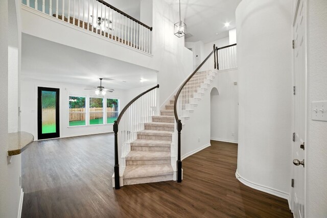 3801 Poppy Hills Cv, Round Rock, TX 78664 - entryway with wood finished floors, a high ceiling, stairs, ceiling fan, and arched walkways