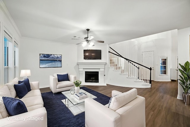 3801 Poppy Hills Cv, Round Rock, TX 78664 - living area with stairs, wood finished floors, ceiling fan, a fireplace with raised hearth, and crown molding