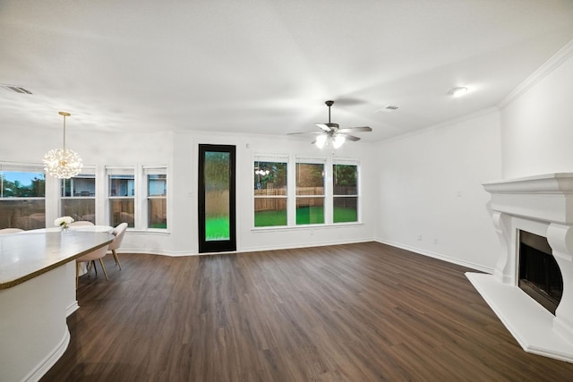 3801 Poppy Hills Cv, Round Rock, TX 78664 - living room featuring a fireplace with raised hearth, dark wood-type flooring, a ceiling fan, a chandelier, and crown molding