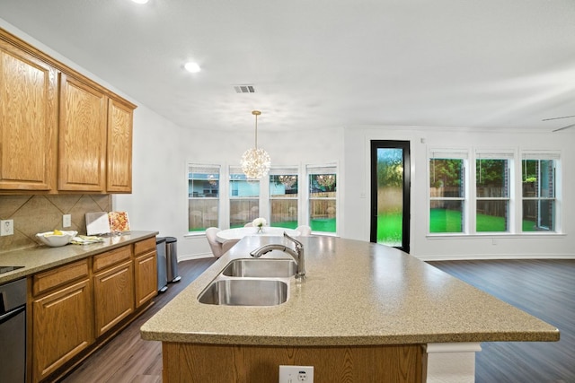 3801 Poppy Hills Cv, Round Rock, TX 78664 - kitchen featuring dark wood-type flooring, decorative backsplash, a kitchen island with sink, pendant lighting, and recessed lighting