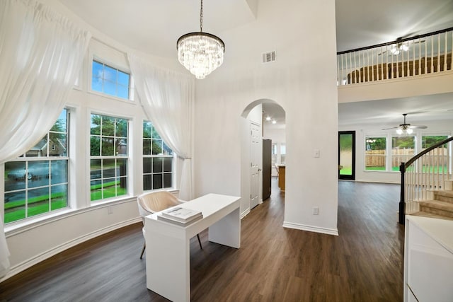 3801 Poppy Hills Cv, Round Rock, TX 78664 - unfurnished office featuring arched walkways, dark wood-style flooring, a towering ceiling, a ceiling fan, and a chandelier