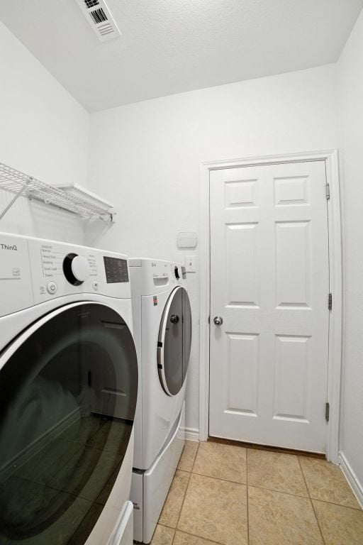 3801 Poppy Hills Cv, Round Rock, TX 78664 - washroom featuring washer and clothes dryer and light tile patterned floors