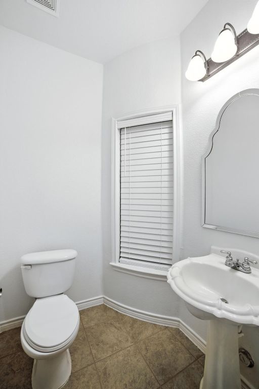 3801 Poppy Hills Cv, Round Rock, TX 78664 - half bathroom with toilet and tile patterned floors
