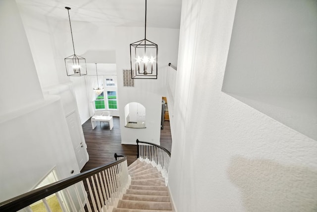3801 Poppy Hills Cv, Round Rock, TX 78664 - stairway with wood finished floors, a high ceiling, and a chandelier