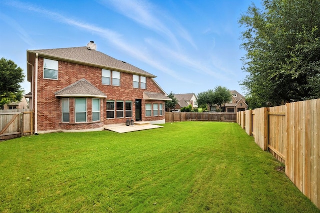 3801 Poppy Hills Cv, Round Rock, TX 78664 - rear view of property featuring brick siding, a chimney, a patio, a fenced backyard, and a shingled roof