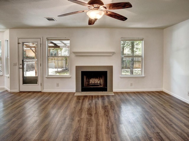 117 High Point Blvd, Cedar Creek, TX 78612 - unfurnished living room with wood finished floors, a tile fireplace, and ceiling fan