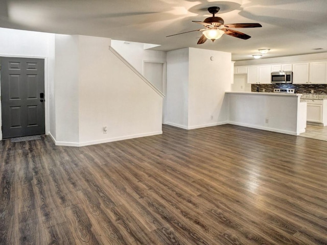 117 High Point Blvd, Cedar Creek, TX 78612 - unfurnished living room featuring dark wood-style floors and ceiling fan